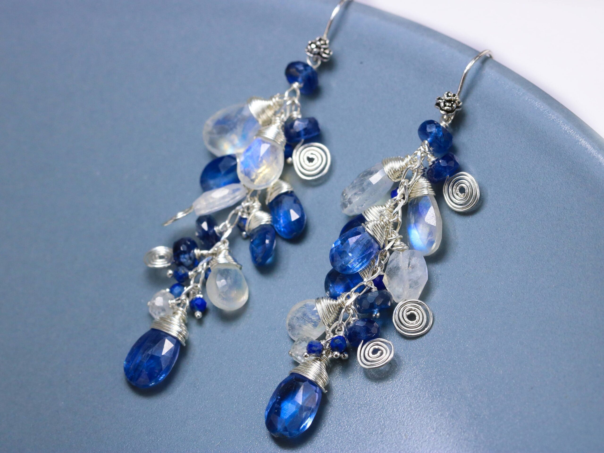 Blue oval and round  kyanite beads with silver highlights drop earrings.